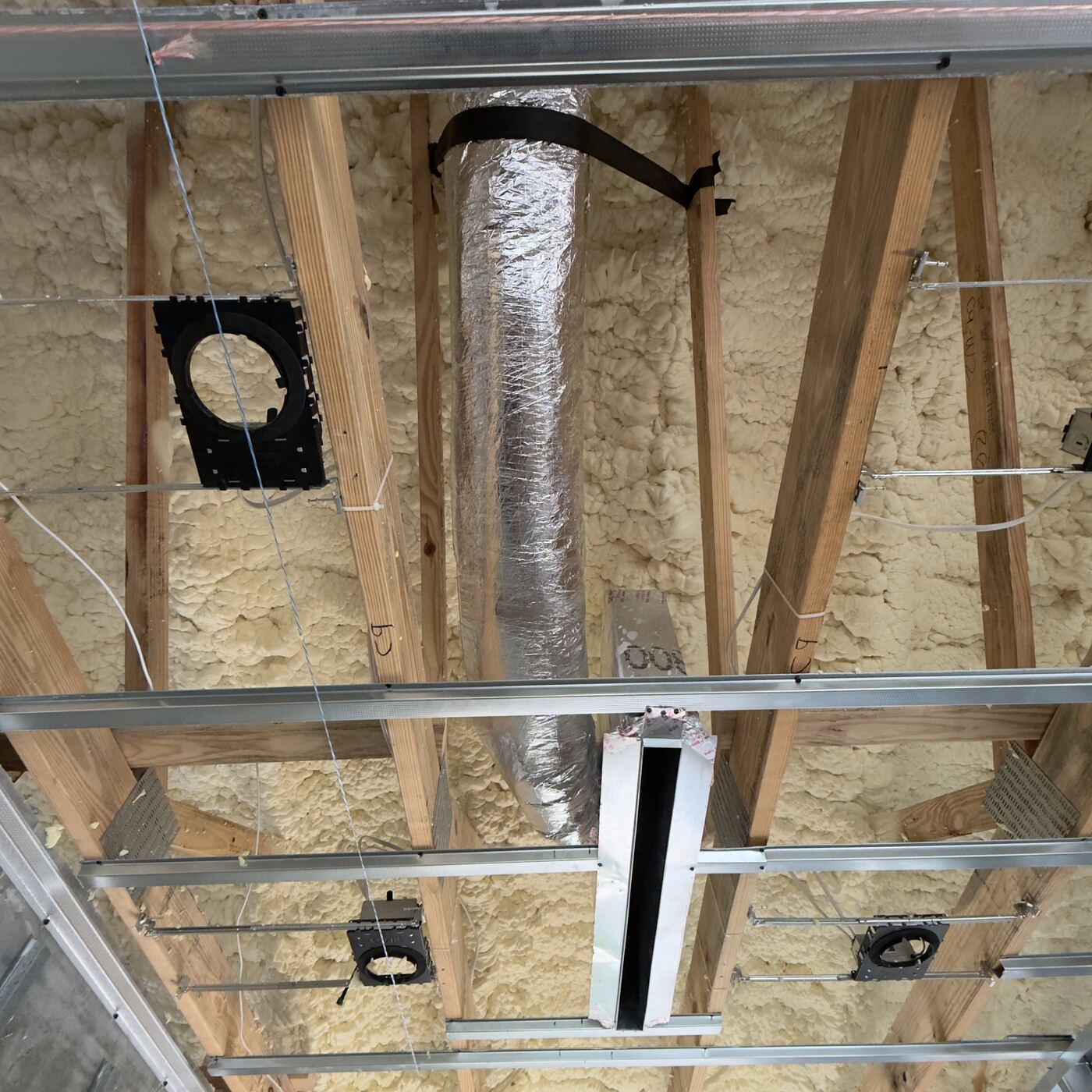 New flex ductwork installed in open ceiling framing